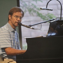 David Grinney playing piano at church